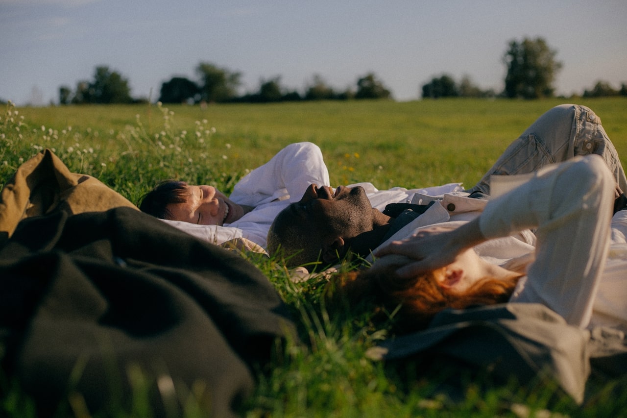 group of friends lying in grass on sunny day