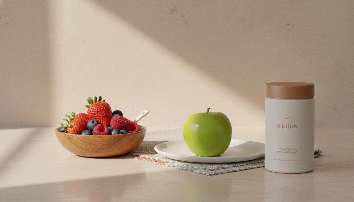 Minimalist kitchen counter with a bowl of mixed berries, an apple, and Tonum Motus supplement; fruits that burn belly fat visual for healthy weight support