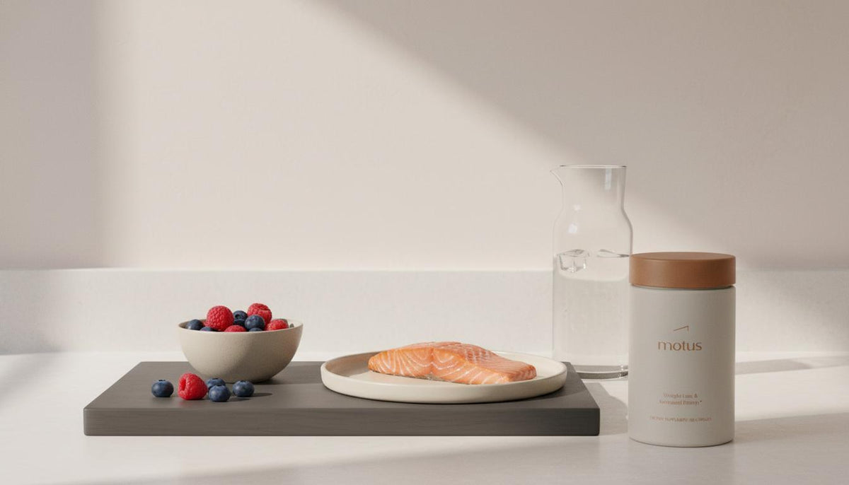 Minimalist kitchen still life with berries, filleted fish, carafe and a Motus supplement container — What are three foods cardiologists say not to eat?