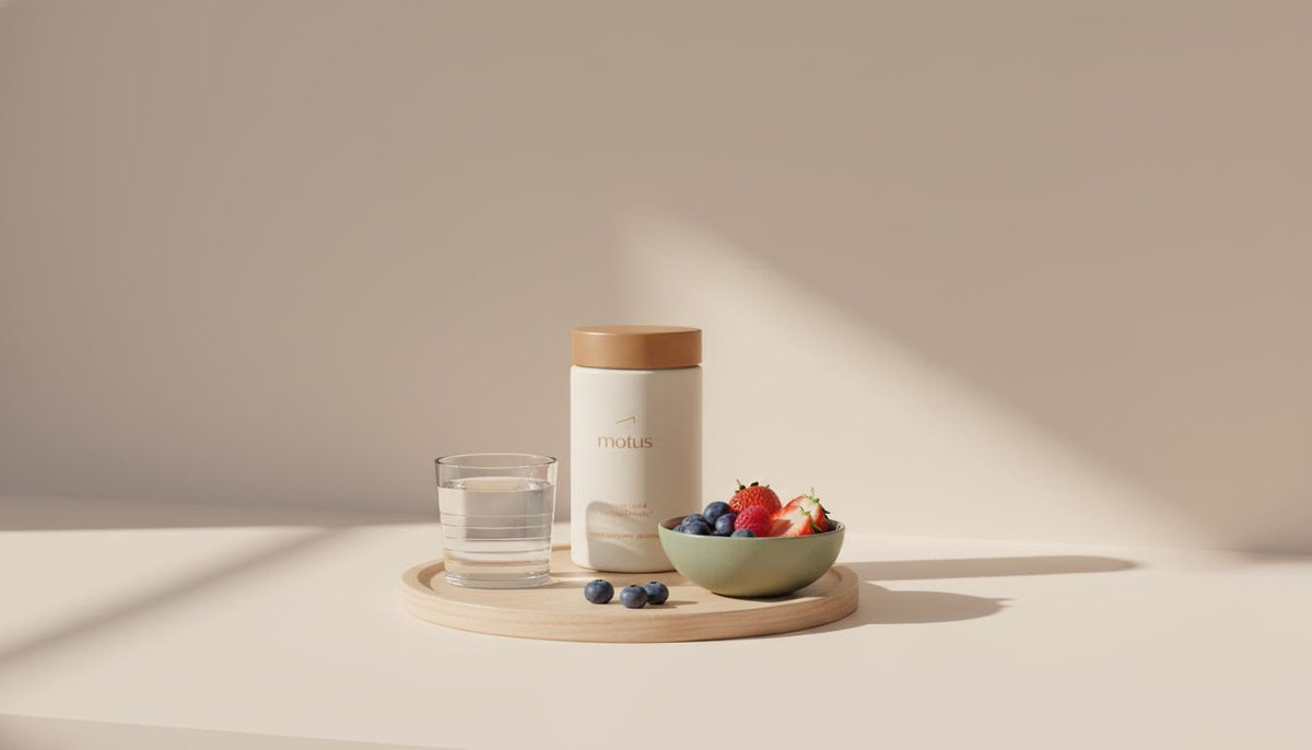 Minimalist kitchen counter with Tonum Motus jar, bowl of berries and glass of water on a wooden tray in soft morning light — best meal replacement shake