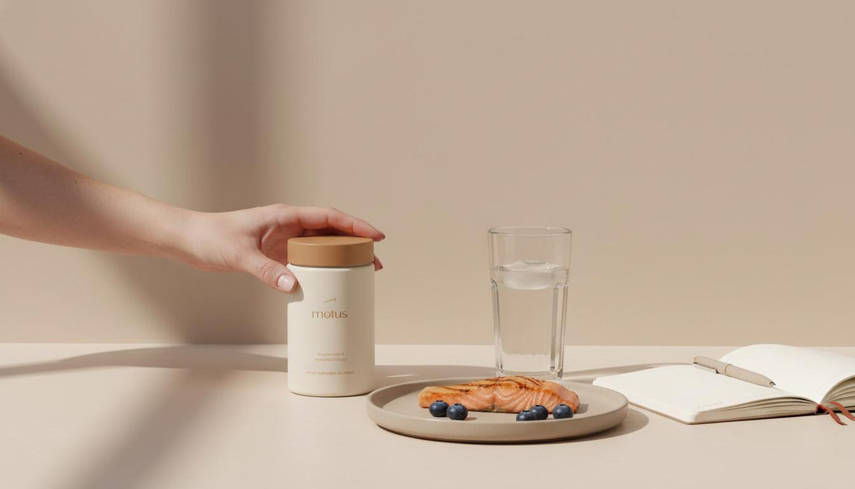 Minimalist kitchen scene with a Tonum Motus jar beside fish and berries, glass of water and notebook, suggesting daily creatine for women habit.
