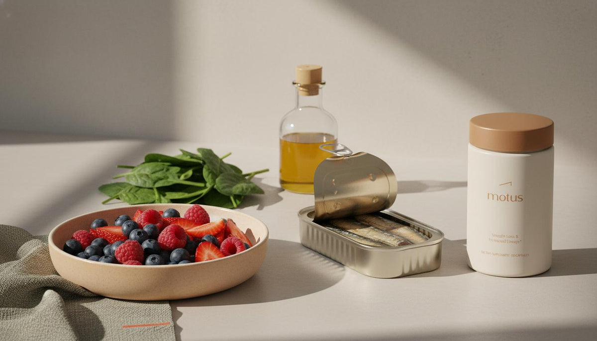 Minimalist kitchen counter with mixed berries, sardines, olive oil, leafy greens and a small Tonum product jar, illustrating what foods improve the brain.