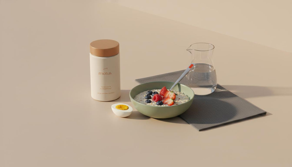 Minimalist kitchen counter with Motus supplement and oatmeal with berries and a halved egg, illustrating a simple healthy breakfast and 30g protein per meal.