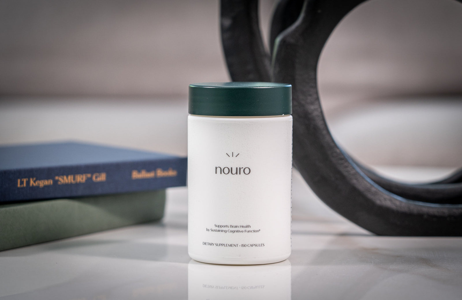 container of nouro cognitive health supplement on a table next to books and objects