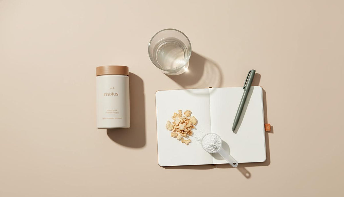 Minimalist flat-lay of Tonum Motus supplement bottle with glass of water, open notebook and konjac flakes illustrating are appetite suppressant pills effective