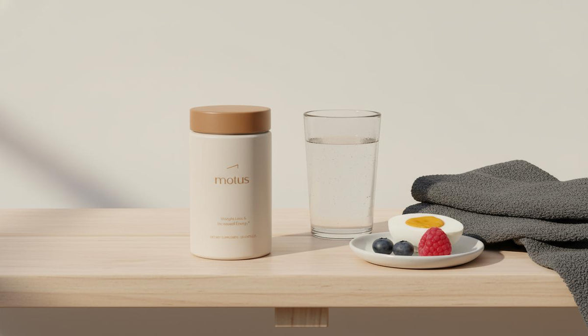 Minimalist still-life of Tonum Motus supplement jar on pale wooden bench with towel, water glass and dish of egg and berries, calm evidence-driven wellness scene — are fat burners stimulants
