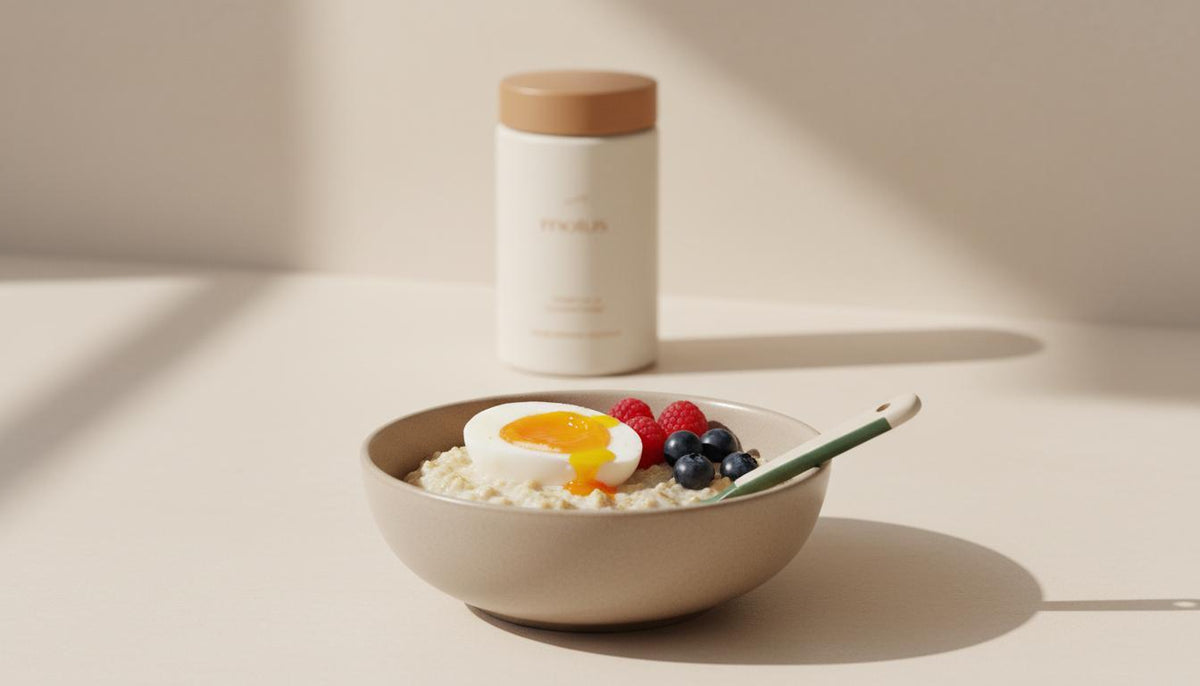 Minimalist kitchen scene: a bowl of oats topped with a halved egg and berries, with a discreet Tonum supplement jar in the background — best protein for skinny guys