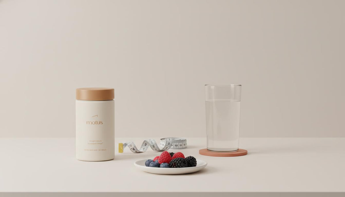 Minimalist kitchen counter with Tonum Motus container beside a measuring tape, glass of water and bowl of berries, evoking metabolic health and berberine for belly fat.