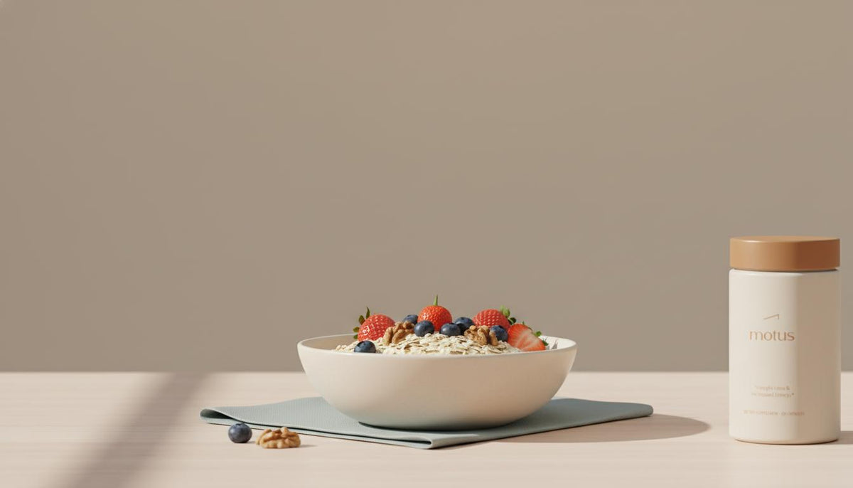 Minimalist kitchen counter with oats, berries and walnuts in a ceramic bowl and Tonum Motus container at the edge, suggesting food-first liver care — do liver detoxes work