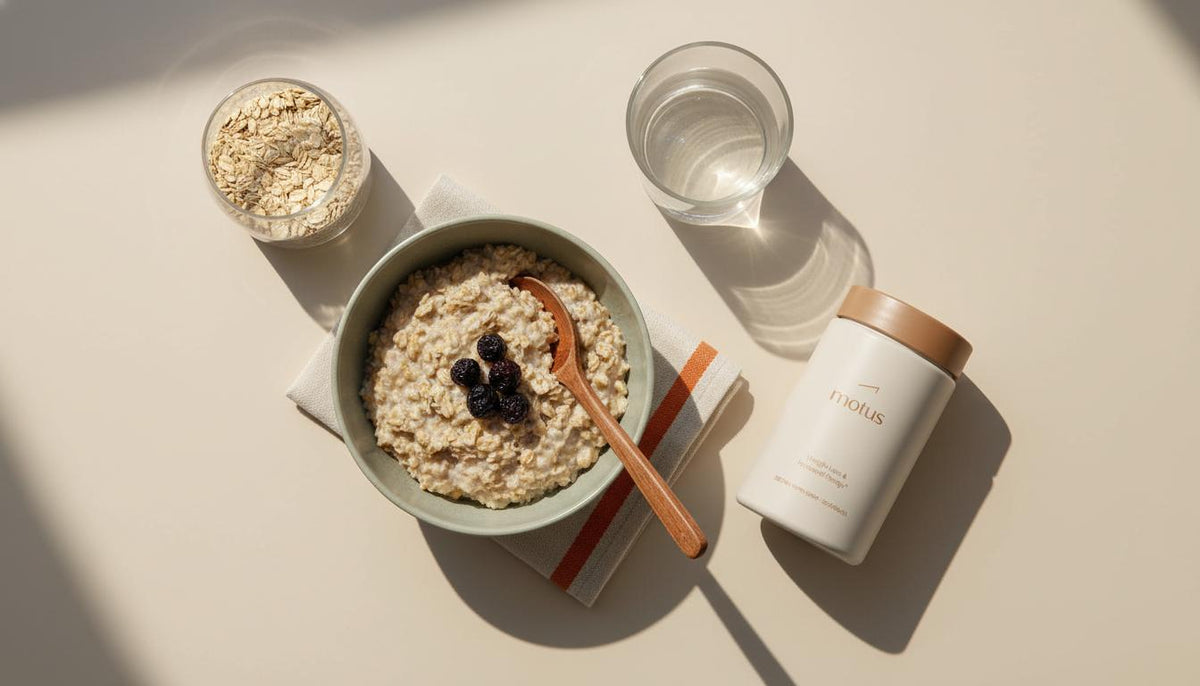 Overhead minimalist kitchen flatlay with bowl of cooled oats, jar of rolled oats, Motus supplement container, glass of water and wooden spoon — how to mimic GLP-1 naturally.