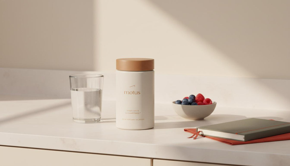 Minimalist kitchen scene with Tonum Motus bottle beside a glass of water, bowl of berries and journal, conveying research-backed wellness and leptin supplements.