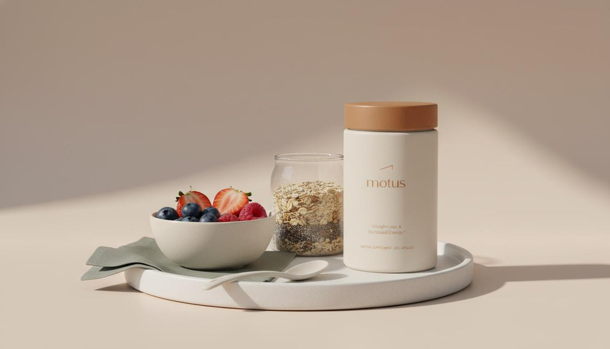 Minimalist still-life of mixed berries, a jar of oats and a Tonum supplement on a ceramic tray illustrating magnesium for sugar cravings