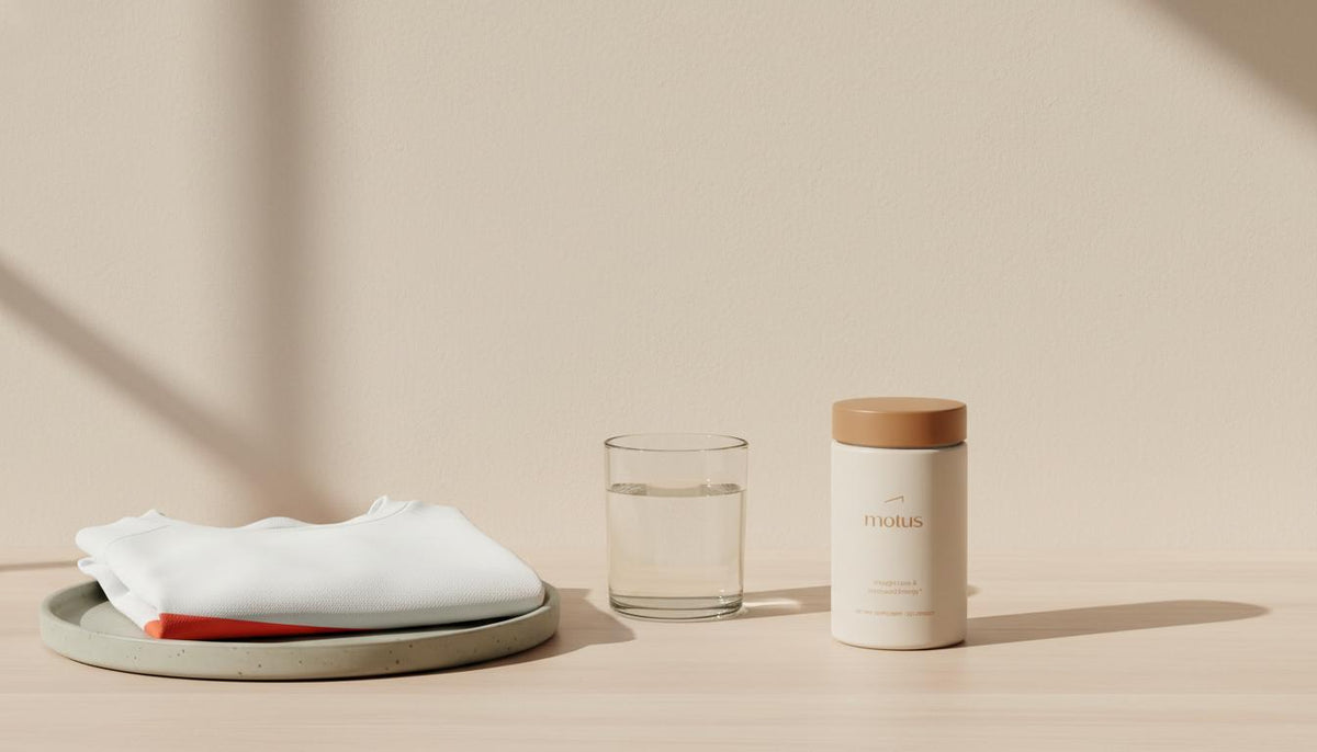 What hormone pills help with weight loss? Tonum Motus container on a minimalist kitchen counter beside a glass of water and folded running shirt, bright clinical lifestyle scene.