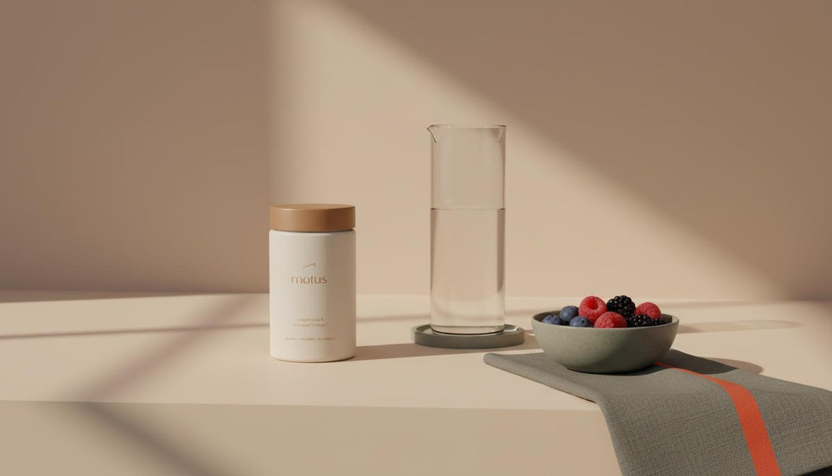 Minimalist sunlit kitchen counter with a Motus supplement jar beside a clear glass carafe and a bowl of berries on a #F2E5D5 background, calm scientific lifestyle — Zepbound