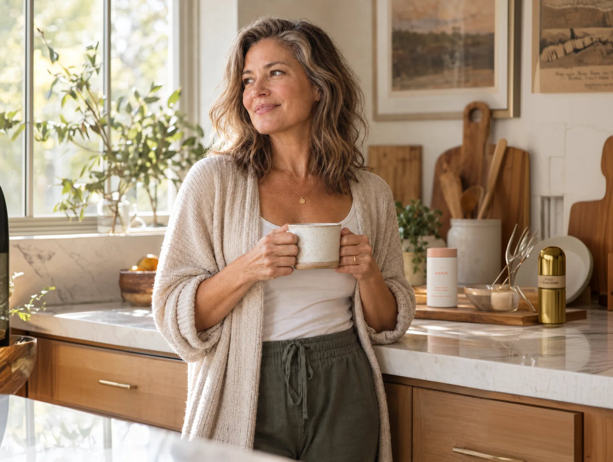 Woman in her fifties holding a mug in her kitchen