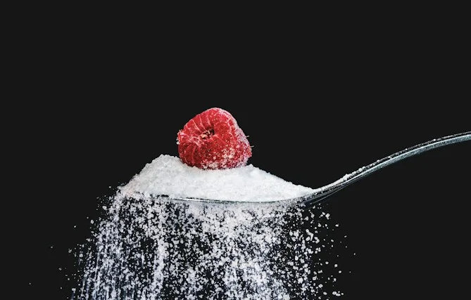 A spoonful of sugar topped with a raspberry